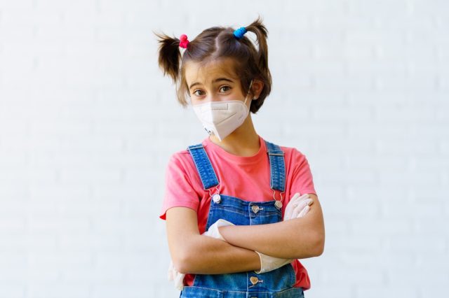 Child girl wearing protective mask against coronavirus