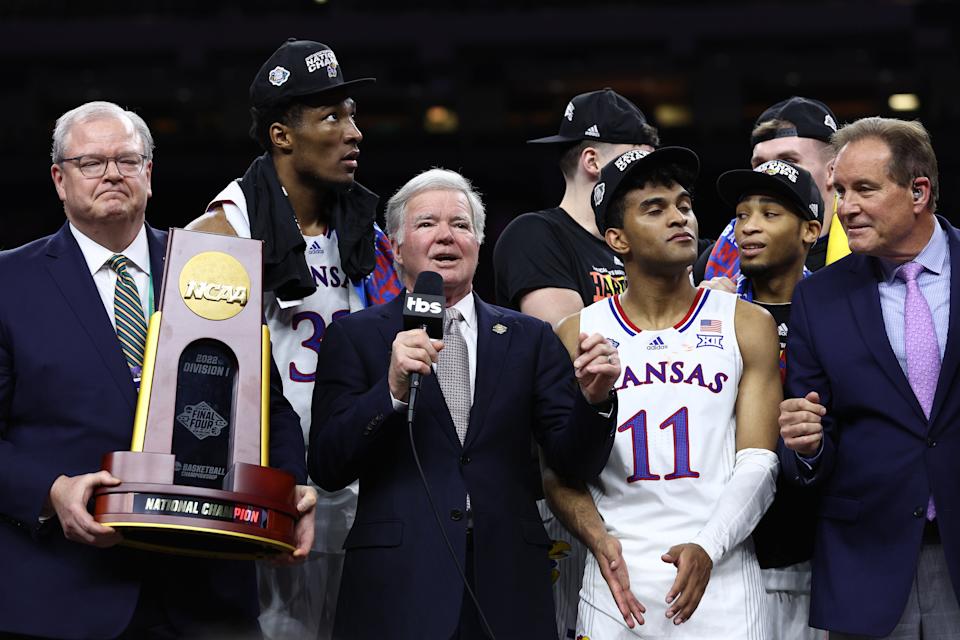 NEW ORLEANS, LOUISIANA - APRIL 04: NCAA President Dr. Mark Emmert presents the championship trophy to the Kansas Jayhawks after defeating the North Carolina Tar Heels 72-69 in the National Championship Basketball Tournament 2022 NCAA Men's Championships at Caesars Superdome on April 04, 2022 in New Orleans, Louisiana.  (Photo by Tom Pennington/Getty Images)